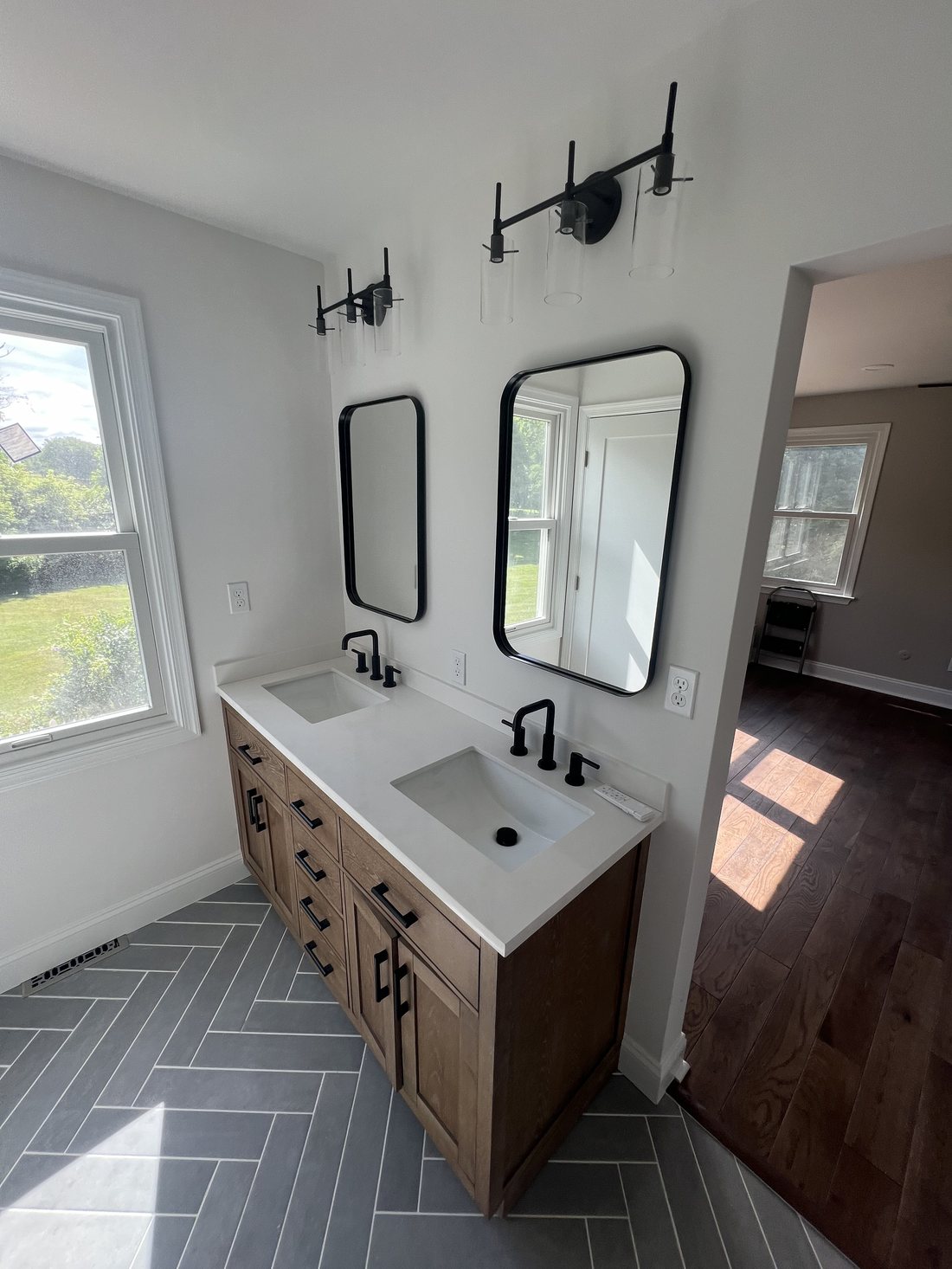 Double vanity bathroom remodel with custom wood cabinetry and herringbone tile, West Chester PA